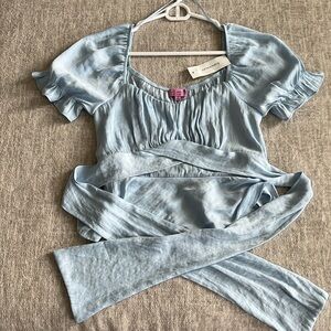 Francesca’s size small baby blue satin blouse with tie in back
